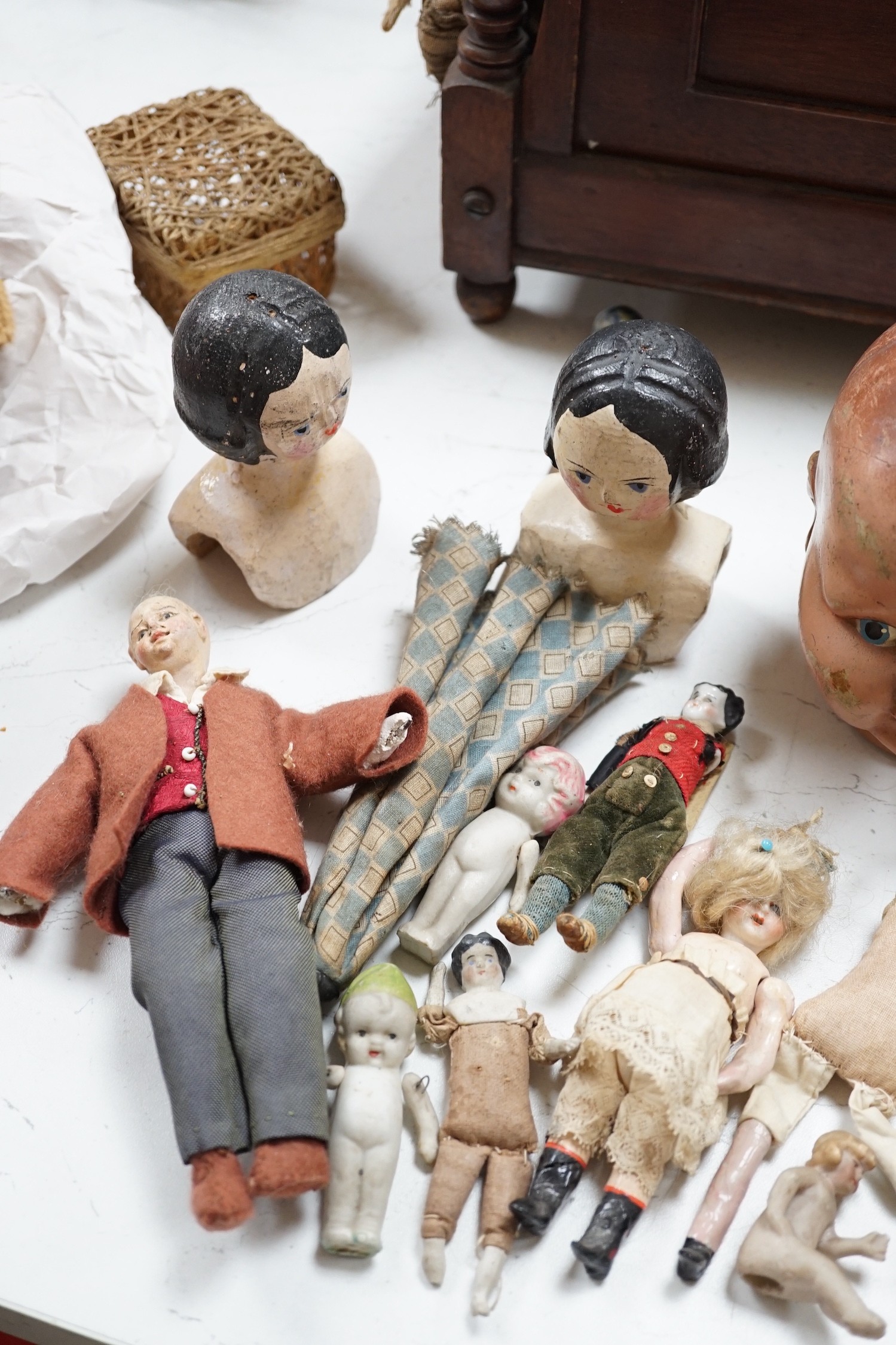 Two Kammer and Reinhardt bisque headed dolls, a wax over composition doll, various other bisque headed dolls and a few single heads and a collection of miniature dolls